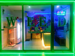 Sawadee Ganja weed shop exterior, Khlong Sam Wa, Bangkok. Bright neon 