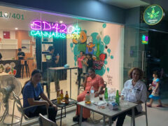 SD420 cannabis shop, Petchkasem Rd, Hua Hin. Exterior showing neon sign, mural, and customers outside. Weed in Thailand.