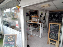 Entrance to SKY WALKER cannabis shop in Ban Tai, Koh Phangan, with discount sign and menu board, selling flowers and smoking accessories.