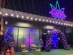 Exterior of Starweed_rama5 in Nonthaburi, Thailand, with neon sign, cannabis leaf decor, and festive decorations; cannabis shop.