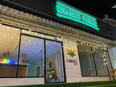 Exterior of SWEED HOME Cannabis Shop in Hua Hin, Thailand, illuminated, with string lights and cannabis shop sign.