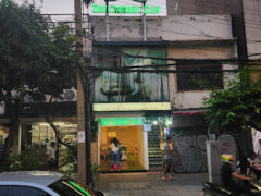 Exterior of Thai Cannabis Club - Asok in Asoke, Bangkok, with lit cannabis leaf sign and shop entrance.