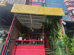 Exterior of The Buds Station by Dr.lek CNX in Nong Kaeo, Hang Dong District, Chiang Mai, a cannabis dispensary with pink facade and greenery.
