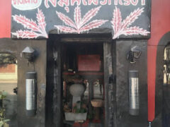 Entrance to ร้านเจได ฟีนิกกัญ weed shop in Nong Chom, San Sai, Chiang Mai. Stylized cannabis leaf art above the door.