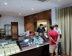 Interior of Weed Connection Chiang Mai dispensary on Singharat Rd, Chiang Mai, showing cannabis flower displays and customers.