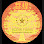 Yellow and orange sun with a small star-like shape in the center, on a black background.