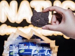 Hand holding THC cookie from Natuclo Cannabis Lounge.