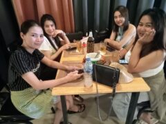 Four women at a table in Horn Pub in Pattaya, Thailand.