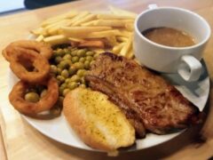 Steak with onion rings, fries, peas, and gravy from Horn Pub in Pattaya.