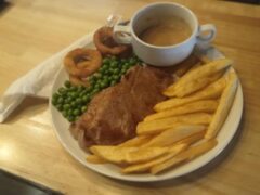 Plate of food at Horn Pub, 82 Soi nern plubwan, Pattaya, including fries, peas, onion rings, and a cup of sauce.