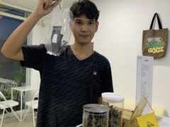 Customer holding cannabis flower at Blessed Ayutthaya, a cannabis shop and coffee shop in Ayutthaya, Thailand.
