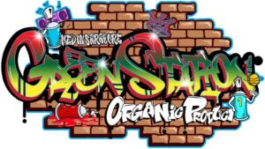 Graffiti art with "Green Station" and "Organic Product" text, spray cans, a basketball, and crown over a brick background.