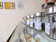 Kor Chor weed shop display of cannabis flower strains and smoking accessories.