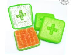 High Island Thailand THC edible gummies in open green container, hand-crafted for dispensaries.