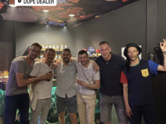 Interior of Dope Dealer cannabis shop in Koh Chang, Thailand, featuring a ceiling mural and customers.