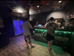 Interior of Dope Dealer cannabis shop in Koh Chang, Thailand, with customers at counter. Weed, drinks.