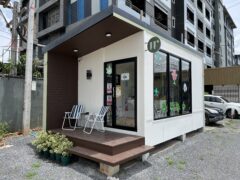 Double U cannabis dispensary exterior, Bang Khae Nuea, Bangkok, Thailand. Weed shop with open sign and cannabis leaf stickers.