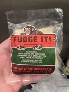 A clear plastic package with white fudge inside, a label that reads 