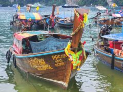 Longtail boats at a pier in Koh Phi Phi, Thailand.