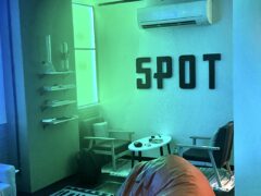 Interior of SPOT cannabis cafe with beanbag chair, tables, chairs, and 