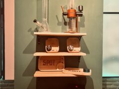 Shelves with smoking accessories, scales and bong inside SPOT.