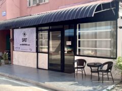 Exterior of SPOT in Thailand with seating and shop signage.