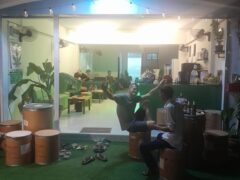 StarWeed Dispensaire cannabis shop exterior in Sala Dan, Ko Lanta, Thailand. People relaxing outside on barrel seating.