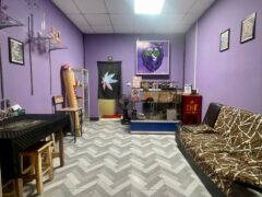 Interior of SIAM HIGH WEED cannabis shop in Khon Kaen, Thailand, showing purple walls and smoking accessories.