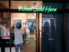 Exterior of Top Genetics weed shop in Chiang Mai, neon 