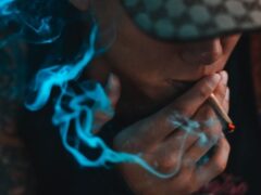Customer smoking cannabis joint at LV Cannabis Boutique, Patong, Phuket, Thailand.