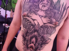 Chest tattoo in Harmony Herb tattoo shop, Pattaya. Features a detailed weeping woman and animal.