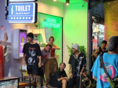 Harmony Herb dispensary on Walking St, Pattaya, Thailand with tattoo shop, cannabis, and people.