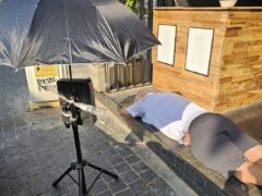 Harmony Herb dispensary exterior, Walking Street, Pattaya. Man sleeping next to store front.