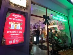 Exterior of Harmony Herb tattoo and cannabis dispensary on Walking St, Pattaya, Thailand, showing sign and entrance.