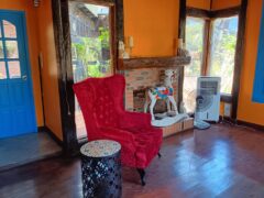 Interior of Chief Weed Dispensary in Mae Rim, Chiang Mai, with a red chair and decorative fireplace.