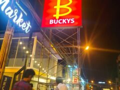 Sign for Bucky's in Pratumnak, Pattaya, where DEEZBUDZ dispensary is located; nighttime scene with people.