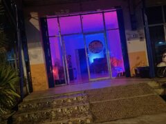Exterior of Fruity Diamonds cannabis shop in Hat Yai, Thailand, with illuminated doorway and scooter.