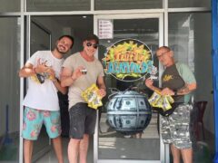 Customers with cannabis flower at Fruity Diamonds, Hat Yai, Thailand, with shop logo and money globe.