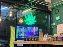 Interior of Channel Weed Store DMK (Donmueng) showing display with menu and cannabis flower, near DMK airport, Thailand.