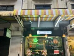 Exterior of Channel Weed Store DMK near DMK Airport, Bangkok, showing a cannabis shop with neon sign, motorcycle, and weed leaf logo.