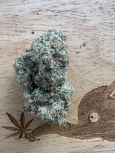 Cannabis bud on wood carving.