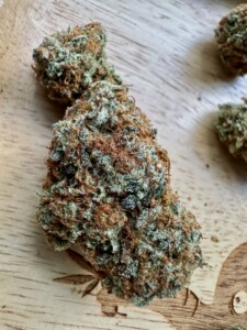 Cannabis bud on a wooden surface.