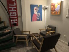 Interior lounge area at Green Nation Dispensary in Bangkok, with artwork and seating for cannabis enthusiasts.