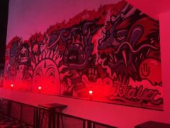 Mural inside BJ's Budshack, Walking Street, Pattaya, Thailand, featuring graffiti art with a red glow.