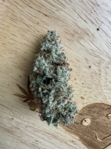 Marijuana bud on a wooden surface.
